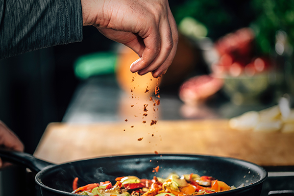 Chef seasoning his food